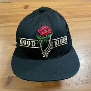 Rue 21:  Black baseball cap with embroidered  skeleton hand and rose good vibes